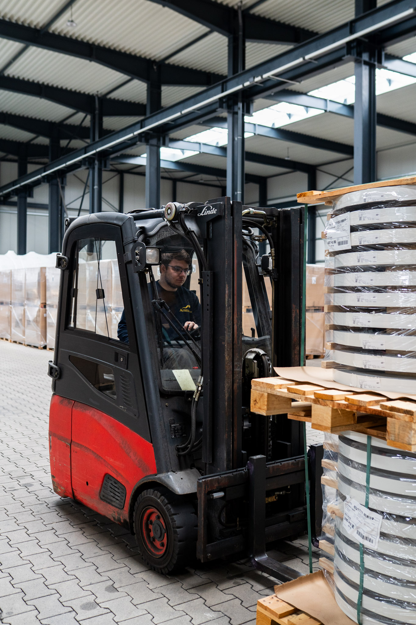 Mitarbeiter der Achenbach Logistik mit Gabelstapler im Hochregallager
